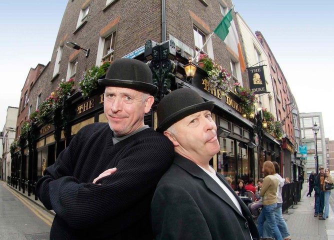 Two people in costume posing outside a pub