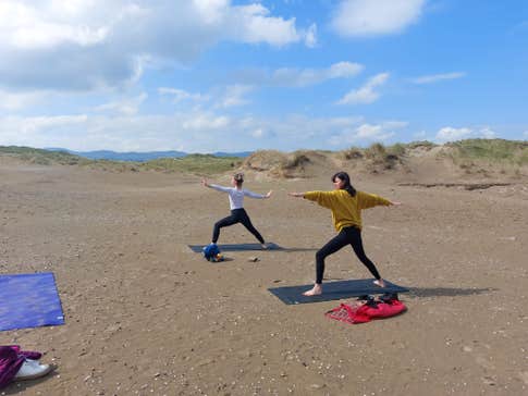 Two women doing yoga on Strandhill Beach in County Sligo, Ireland
