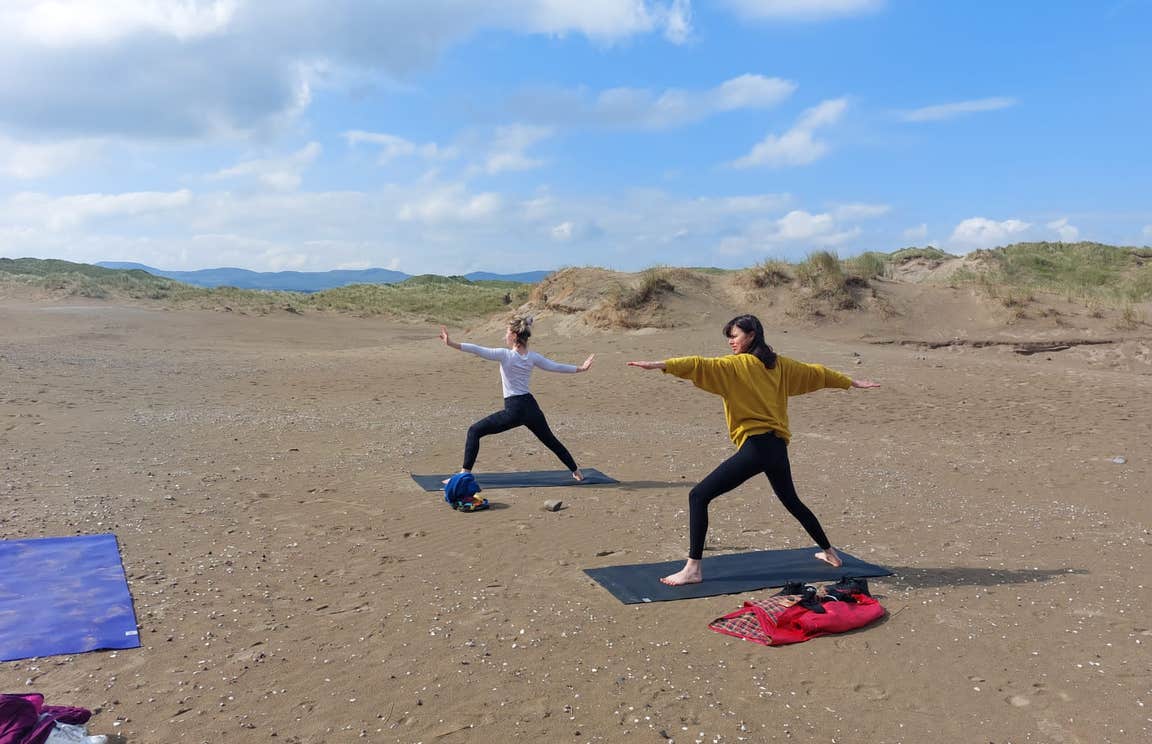 Two women doing yoga on Strandhill Beach in County Sligo, Ireland
