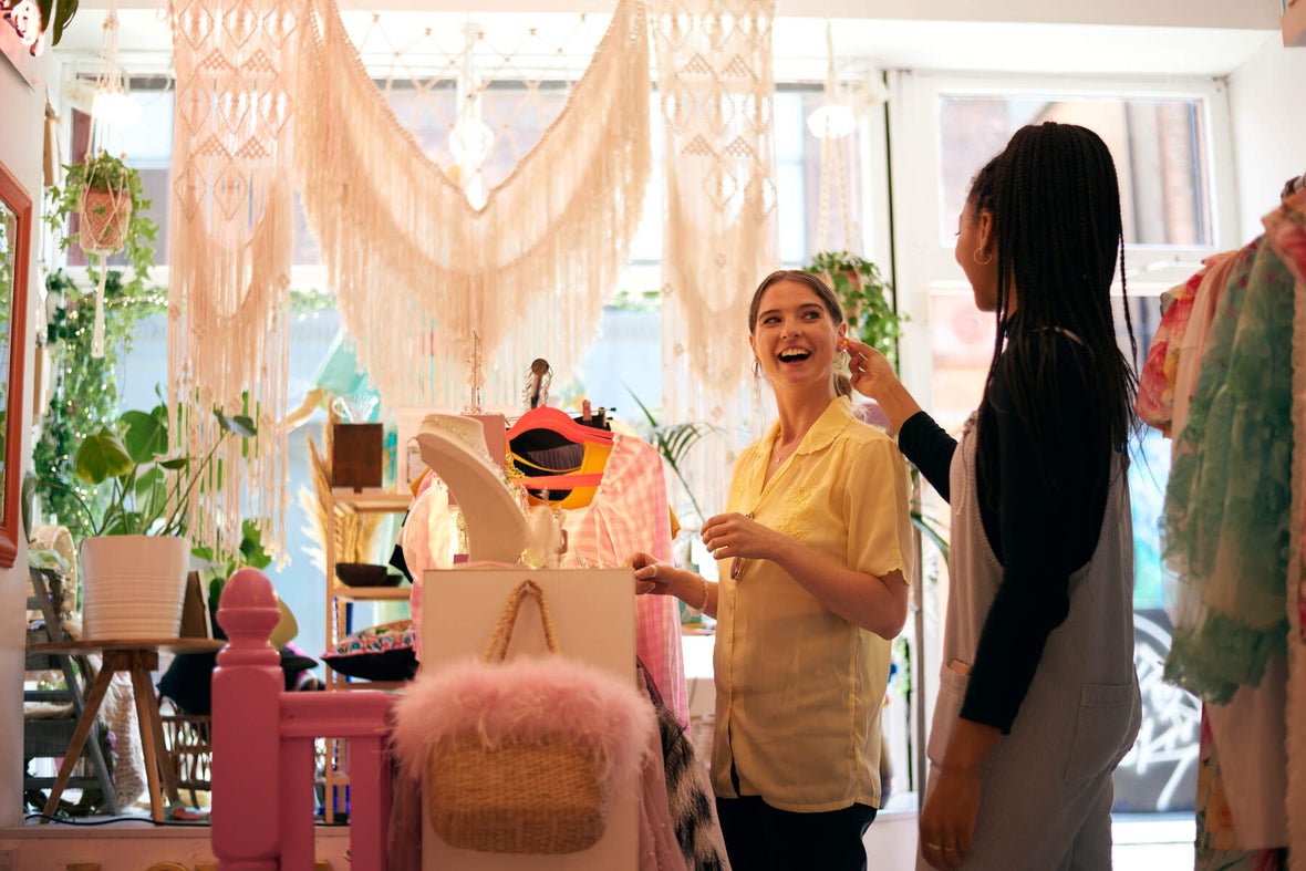 Two women smiling in boutique store Om Diva in Dublin city.