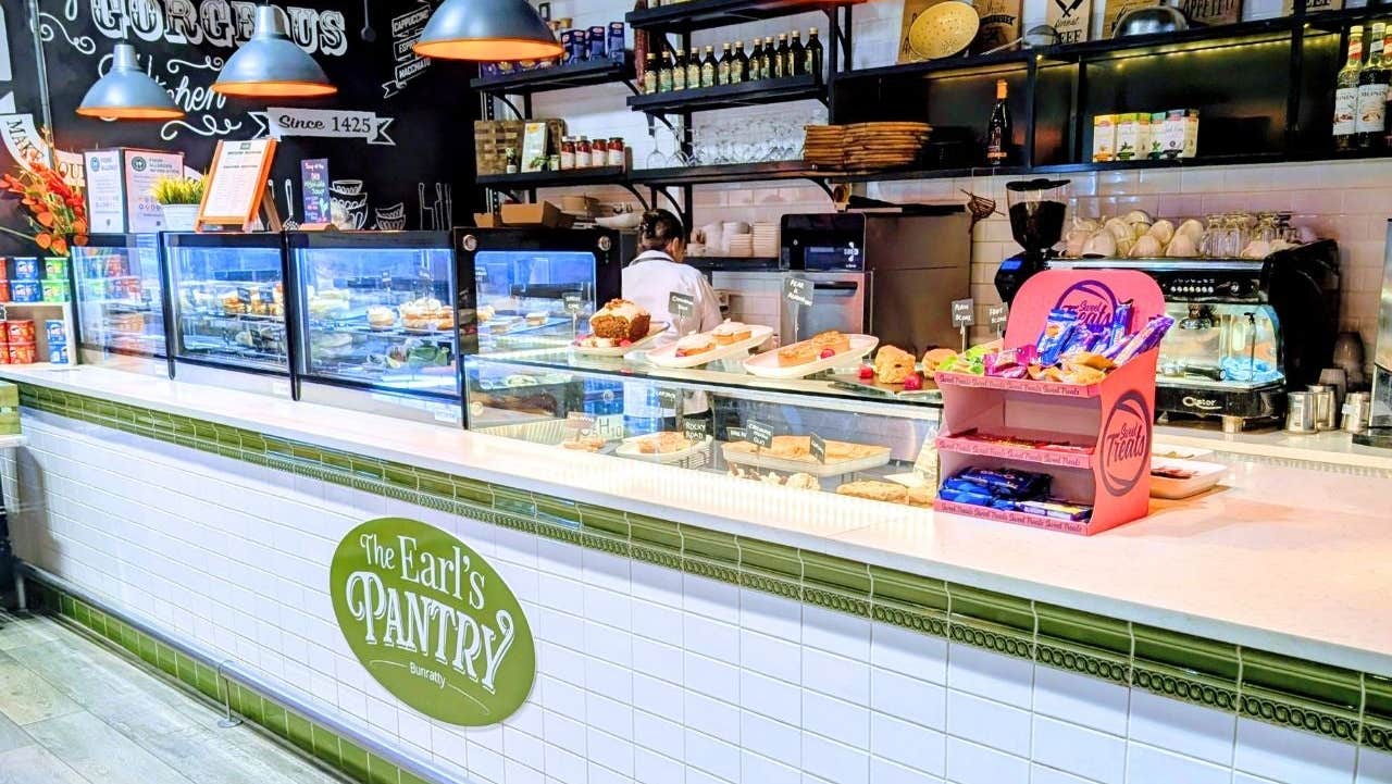 A café counter showcasing a variety of pastries and cakes