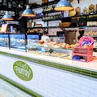 A café counter showcasing a variety of pastries and cakes
