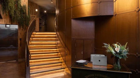 Reception area with a desk and stairs