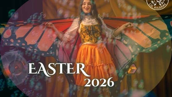 Picture of children's entertainer dressed as a butterfly, surrounded by bubbles