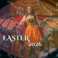 Picture of children's entertainer dressed as a butterfly, surrounded by bubbles