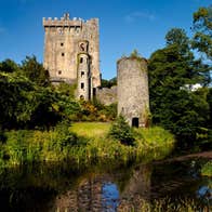 A river beside Blarney Castle in Cork on a sunny day.