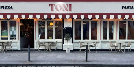 Exterior view of TONI with tables and chair for outside dining 