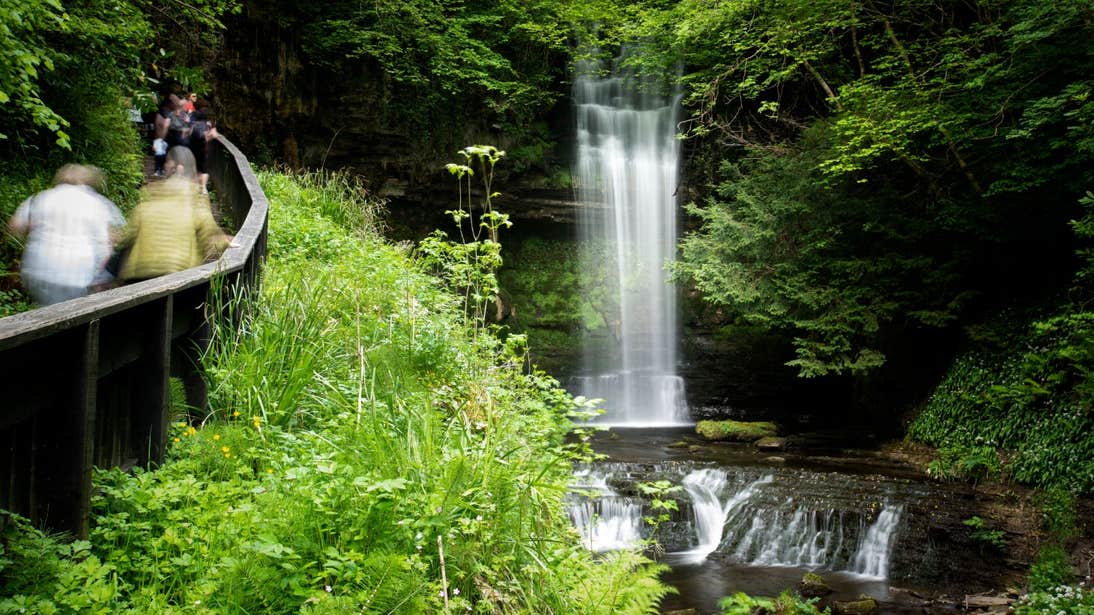 People walking beside Glencar Waterfall, Glencar, County Leitrim