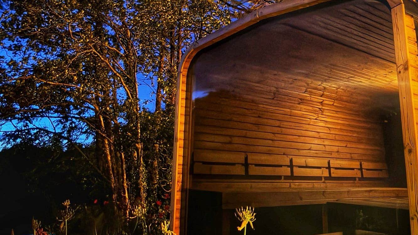 A lakeside sauna by night