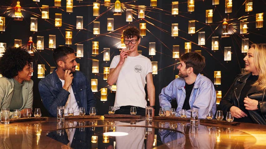 A group of people sampling whiskey