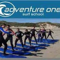 A group of people learning how to surf at Adventure One Surf School