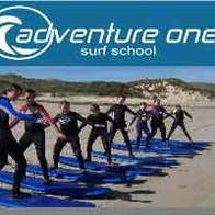 A group of people learning how to surf at Adventure One Surf School