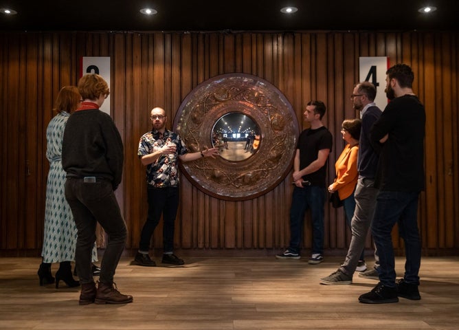 Tour group and guide in a theatre foyer