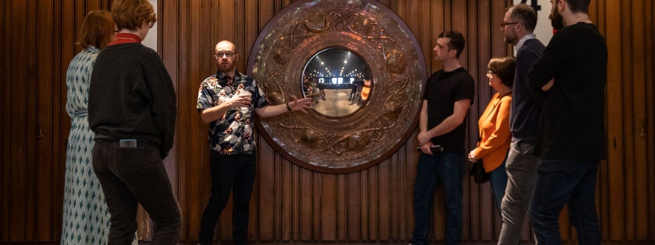 Tour group and guide in a theatre foyer