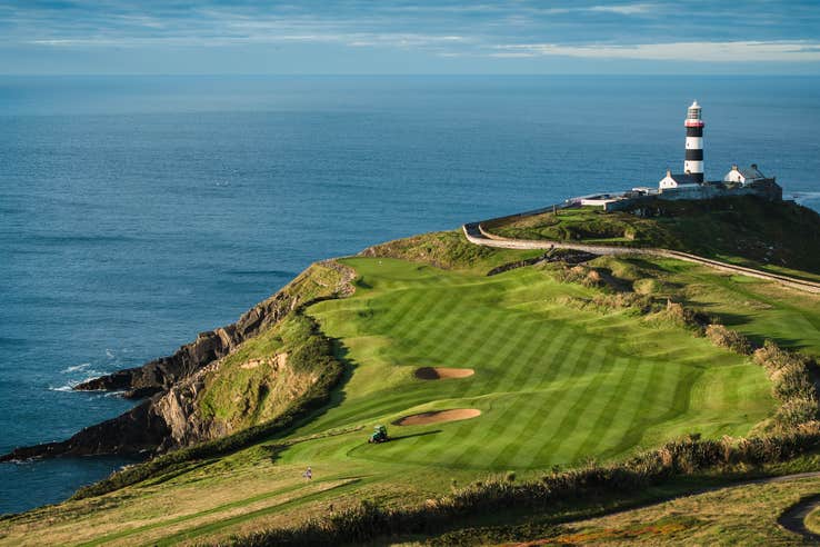 Aerial view of Old Head of Kinsale Golf Links and a lighthouse in County Cork