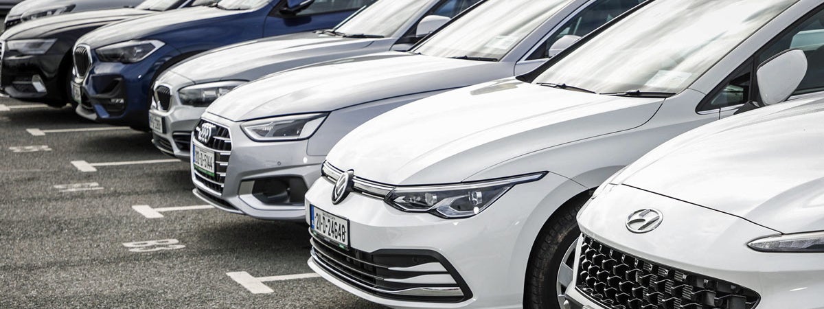 Rental cars parked in a row awaiting collection