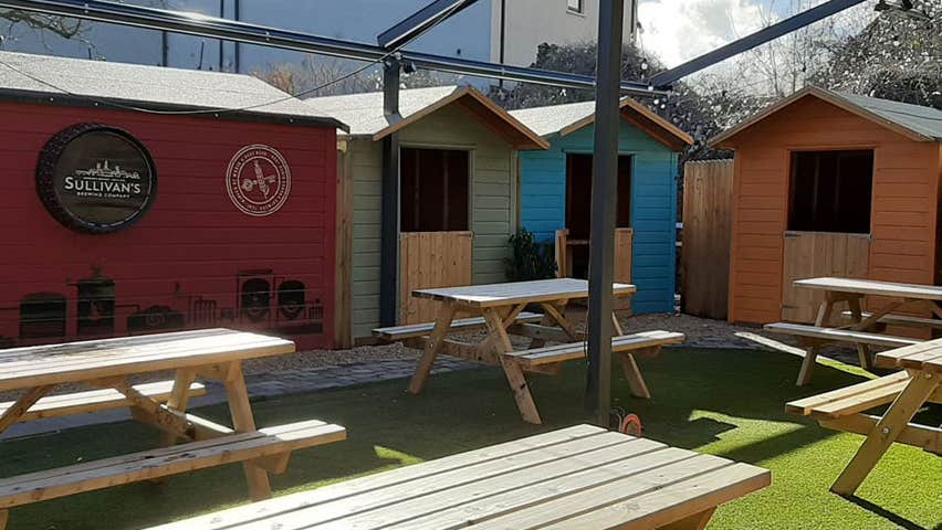 Empty benches in an outside dining area at a pub
