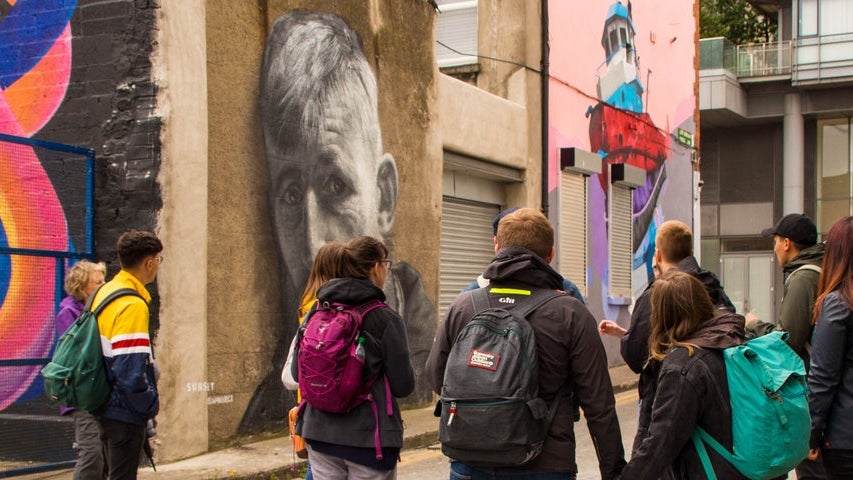 A tour group in Smithfield looking at some street art and graffiti