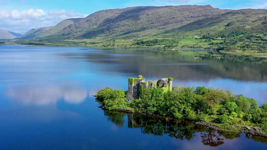 The ruins of a castle on a small island on a lake in Connemara
