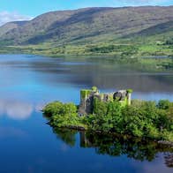 The ruins of a castle on a small island on a lake in Connemara
