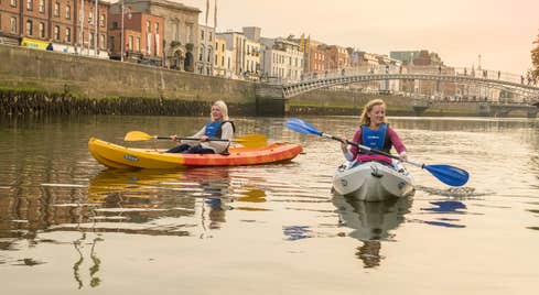 Two people kayaking on the River Liffey in Dublin