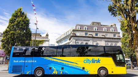 Side view of a blue and yellow bus with citylink written on its side