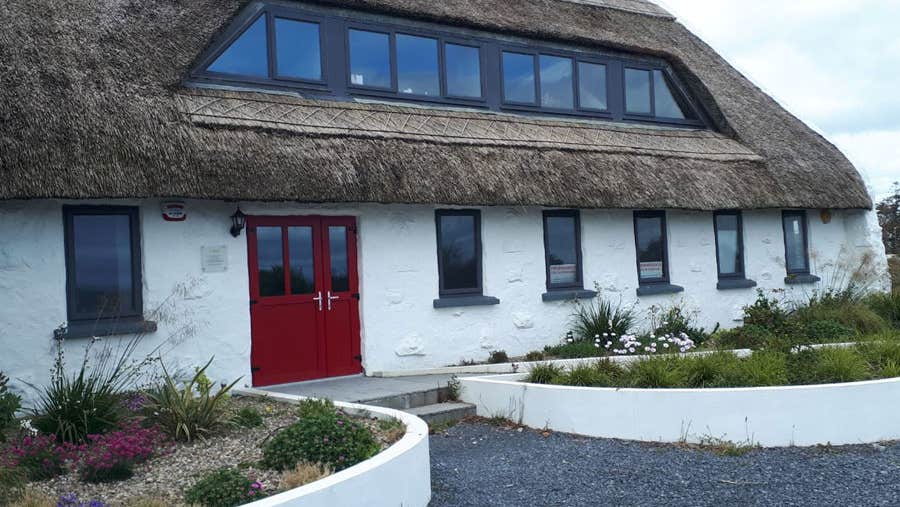 Exterior of the traditional thatched Pota Cafe