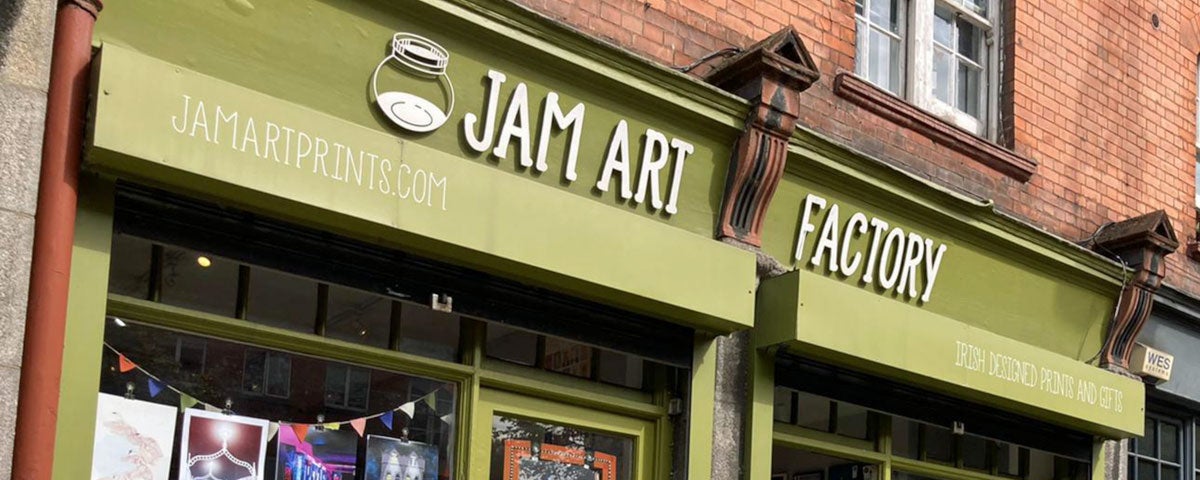 Green shopfront and sign over door saying Jam Art Factory