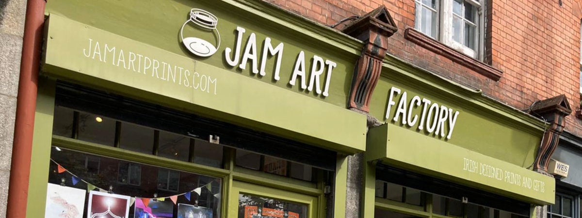 Green shopfront and sign over door saying Jam Art Factory