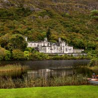 Kylemore Abbey, Connemara, County Galway beside a lake and surrounded by trees