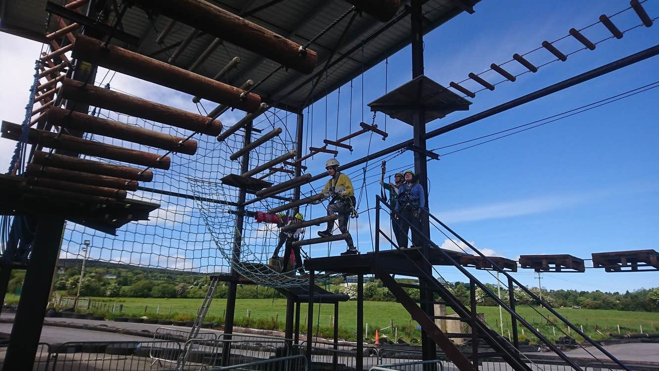 Children with helmets on high ropes at an activity centre