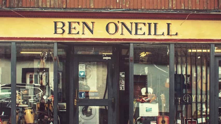 Exterior of Ben O'Neill's Music Shop with glass window with musical instruments on display