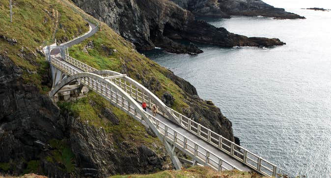 People walking across the bridge at Mizen Head in County Cork.