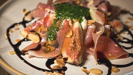 A dish of caramelised figs and Parma ham from the menu at TONI