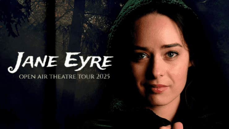 Face of a gently smiling woman wearing a dark bonnet against dark background of forest.