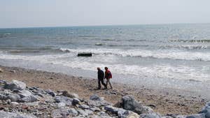 Couple walking on Garryvoe Beach