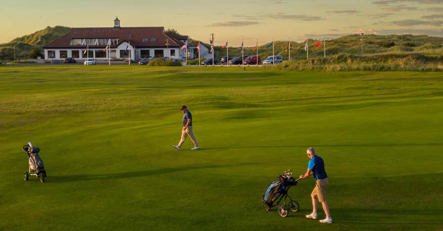 Golfers playing Enniscrone Golf Club in County Sligo