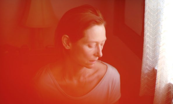 Film Memoria with Tilda Swinton, pictured sitting by a window looking down