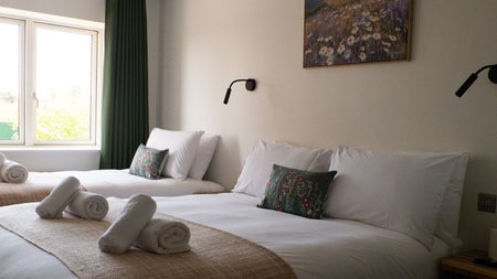 Double and single beds with white sheets