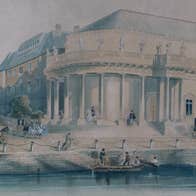 An old drawing showing the Crawford Art Gallery in a previous century with water and a dock outside and horses and carriages.