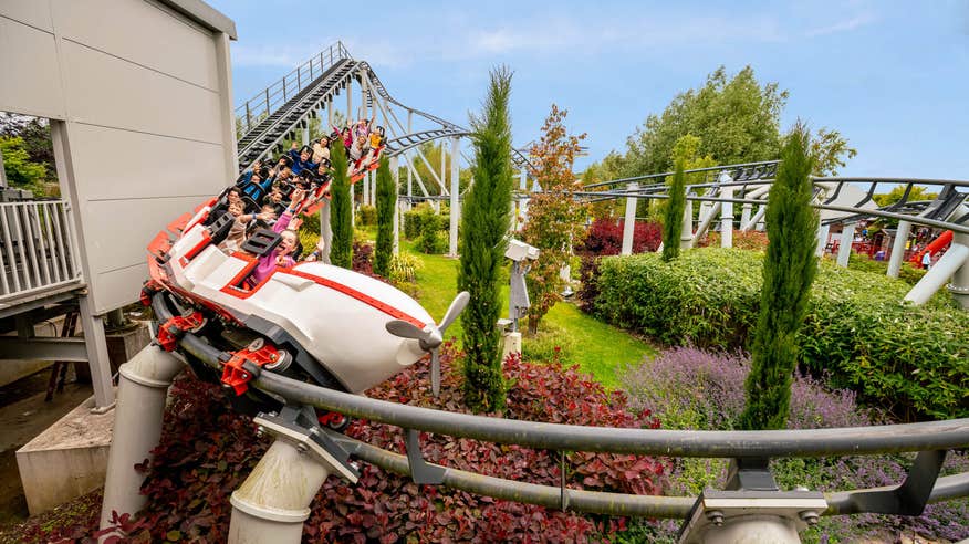 Roller coaster winding around Emerald Park.