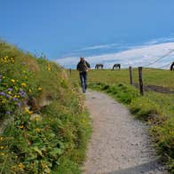 A man walking along a country side path