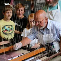 Science Demo Day at National Print Museum - a man demonstrating an old machine to onlooking children.
