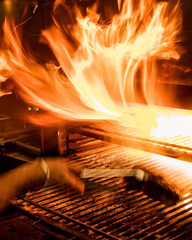 A chef grilling steaks