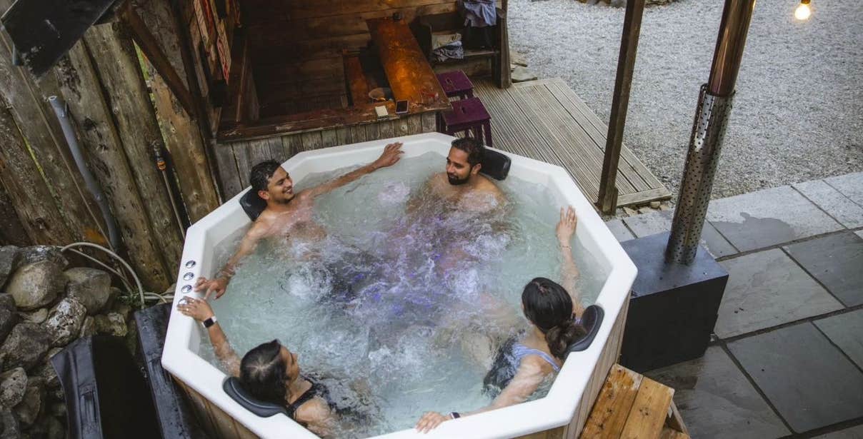 Four people in a hot tub at Mayo Glamping in County Mayo