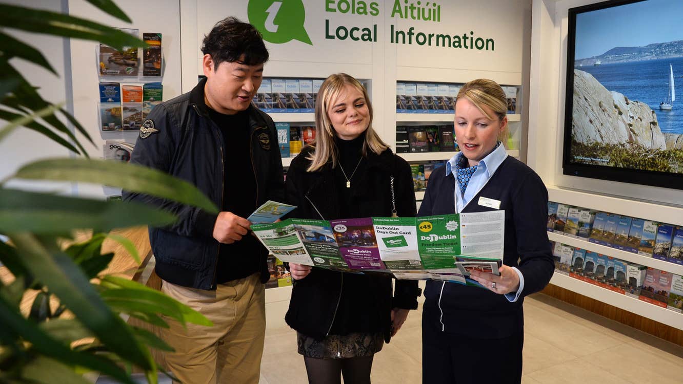 A member of staff at Dublin Tourist Information Centre Barnardo Square assisting visitors