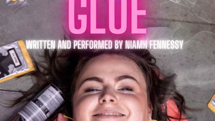 A smiling girl lying on grey floor