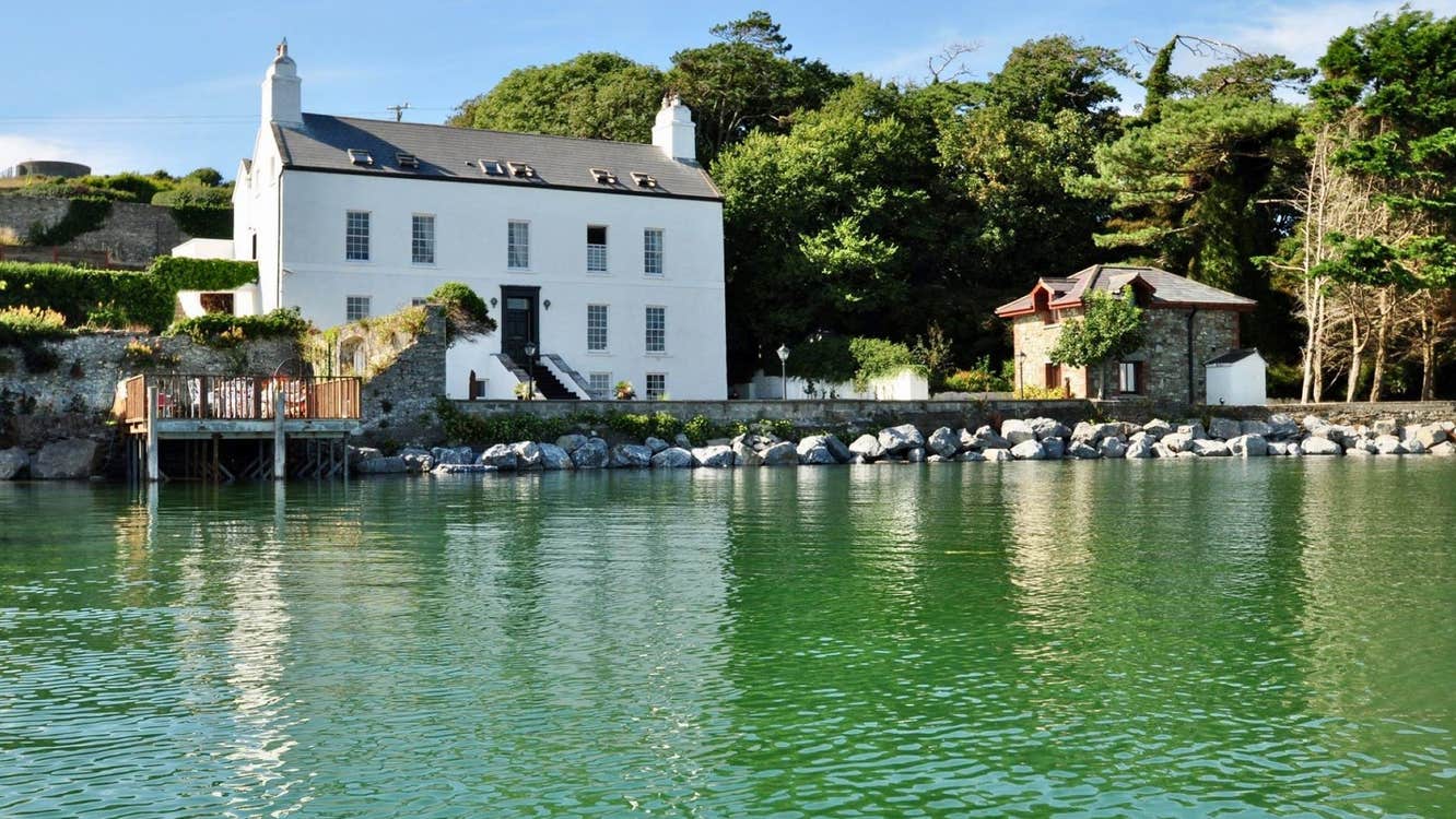 View of a large two storey building overlooking a pier