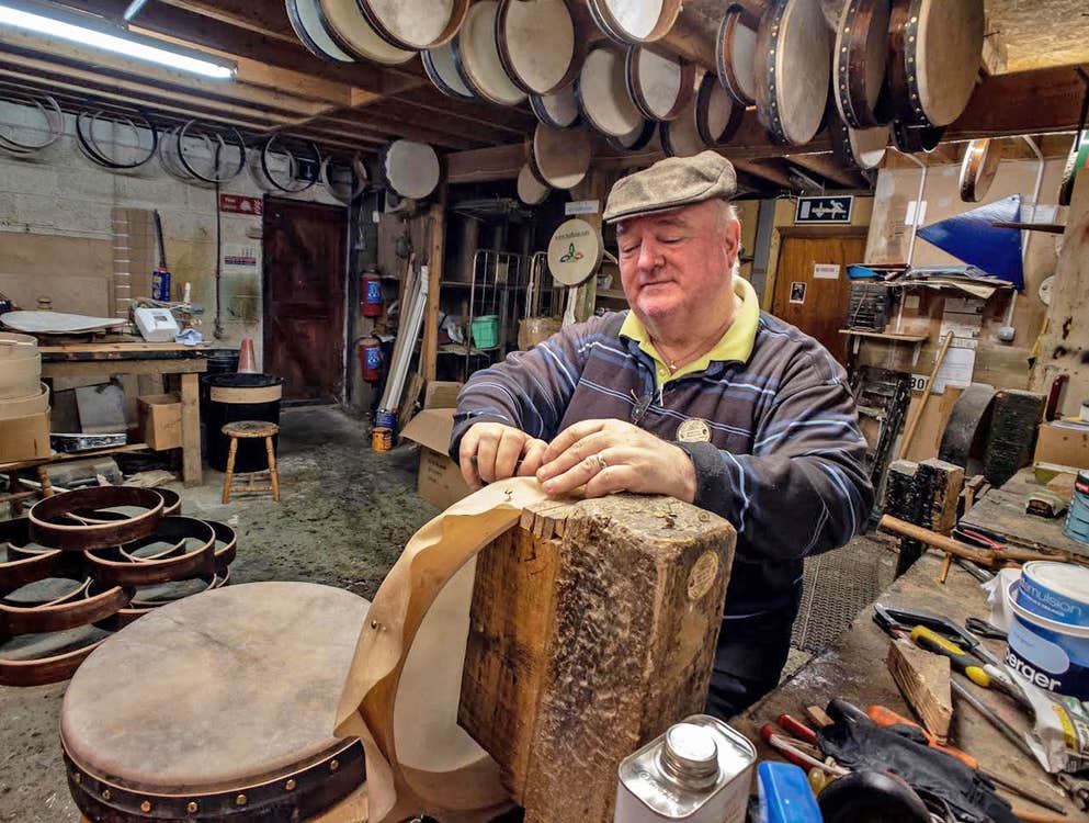 Roundstone Music and Crafts showing a man in a workshop making a bodhran