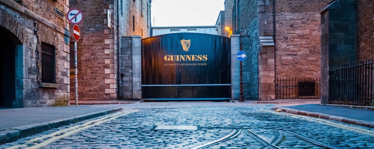The Guinness Storehouse entrance with large gates and cobbled street
